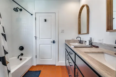 a bathroom with a tub sink and mirror