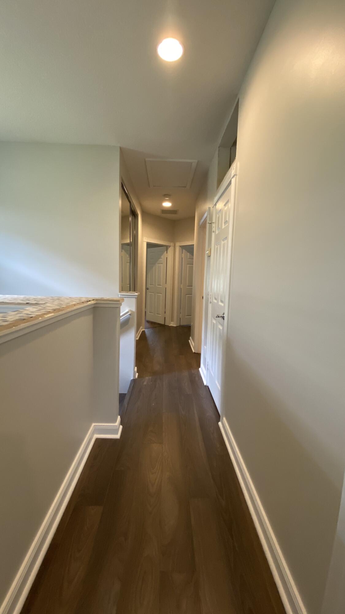 3200 West Community Drive Jupiter, FL 33458 - Photo 15 of 31 a view of a hallway with wooden floor