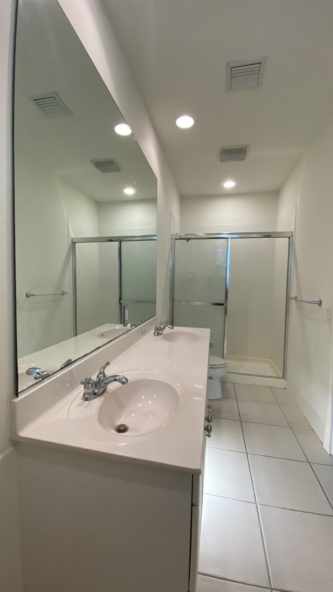 3200 West Community Drive Jupiter, FL 33458 - Photo 25 of 31 a bathroom with a sink and a mirror