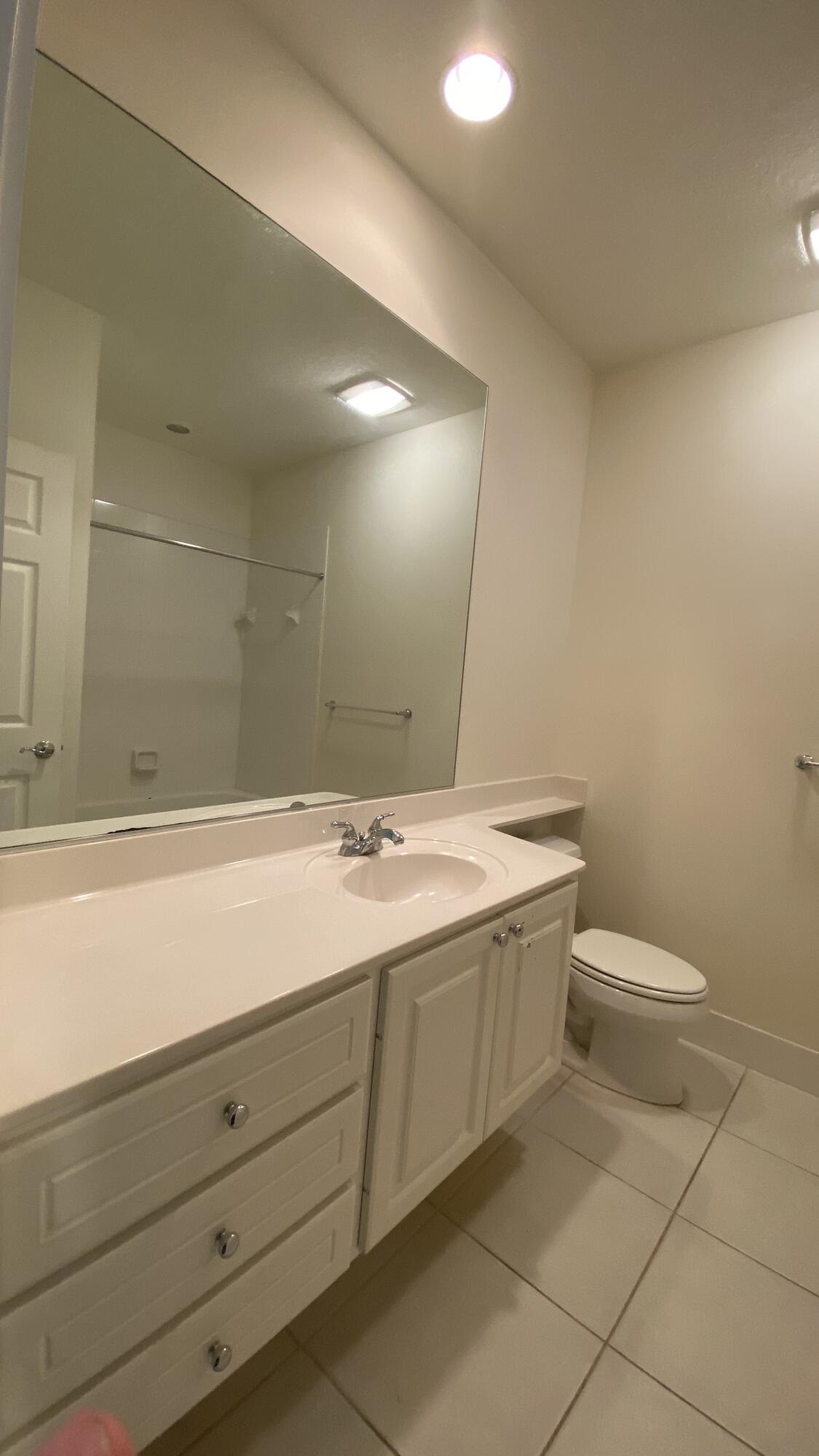 3200 West Community Drive Jupiter, FL 33458 - Photo 27 of 31 a bathroom with a sink and mirror