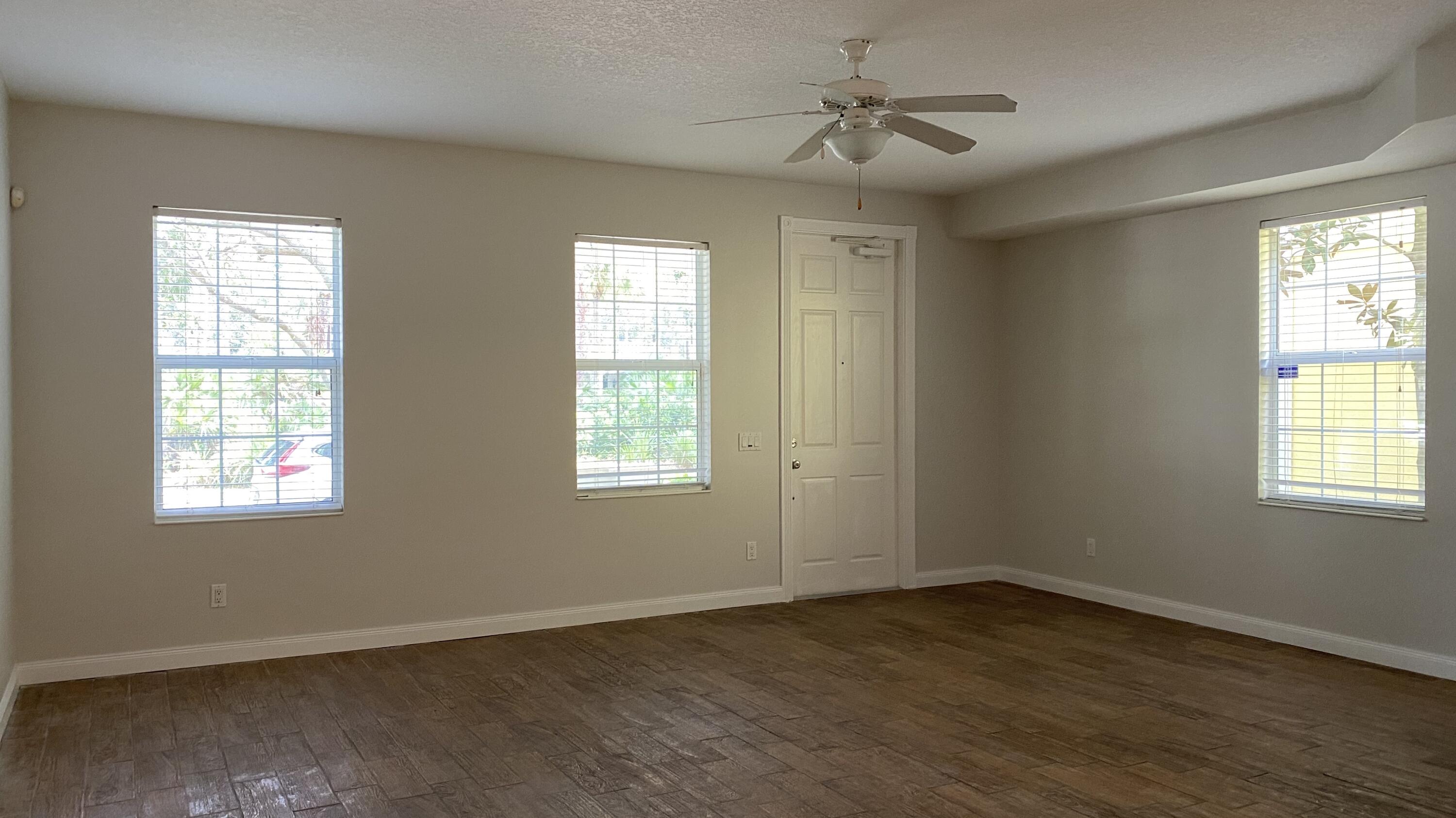 3200 West Community Drive Jupiter, FL 33458 - Photo 9 of 31 a view of an empty room with wooden floor and a window