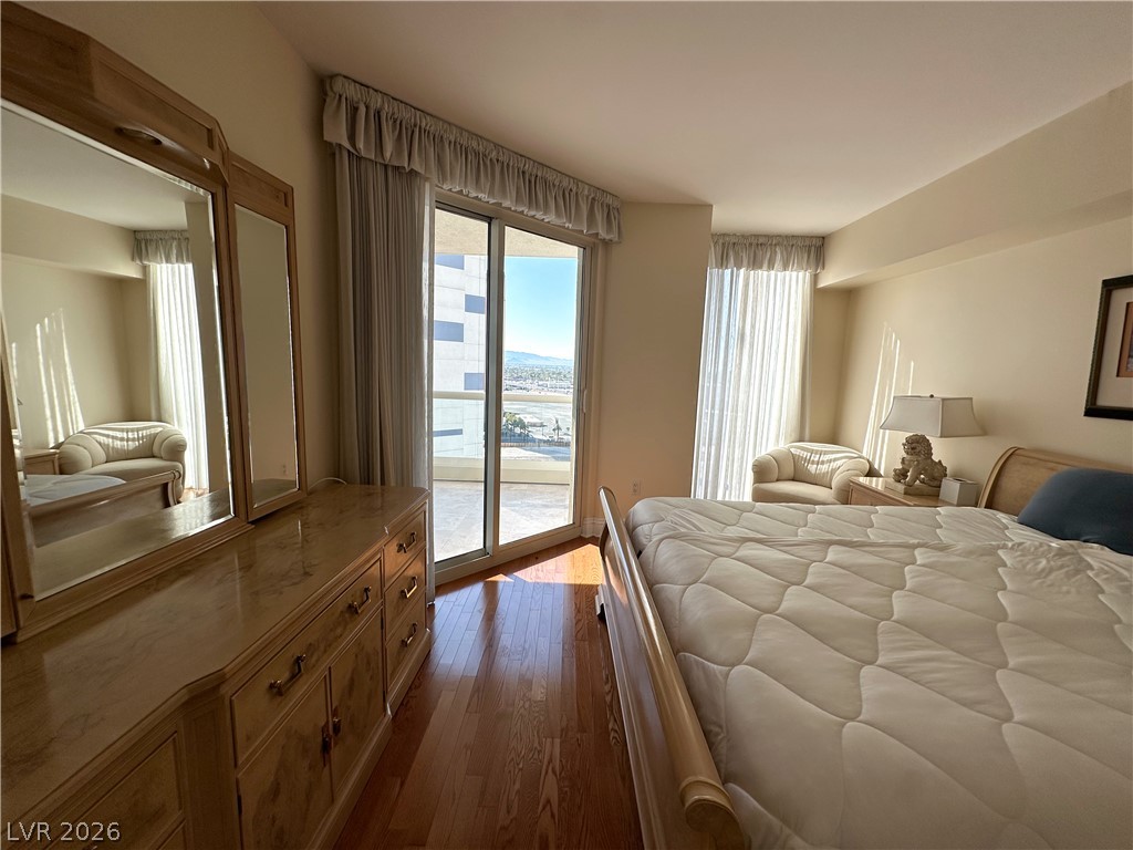 2747 Paradise Road, Unit 1706 Las Vegas, NV 89109 - Photo 16 of 35 Hardwood floors and a private balcony enhance this well-lit bedroom space.