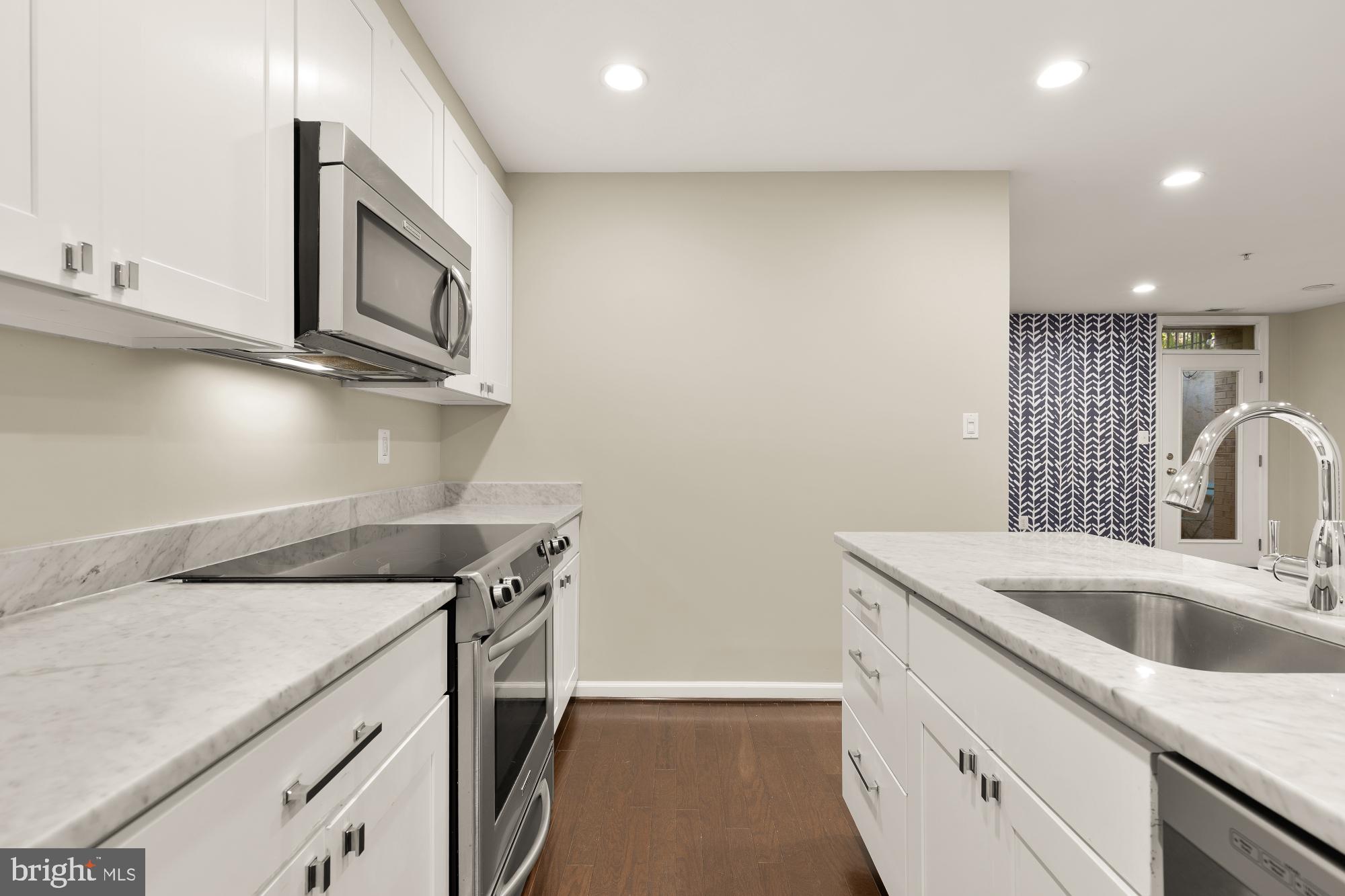 1845 Kalorama Road Northwest, Unit 1 Washington, DC 20009 - Photo 12 of 39 a kitchen with a sink cabinets and a stove