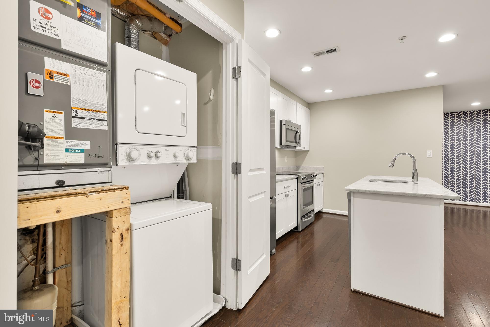 1845 Kalorama Road Northwest, Unit 1 Washington, DC 20009 - Photo 23 of 39 a storage room with washer and dryer