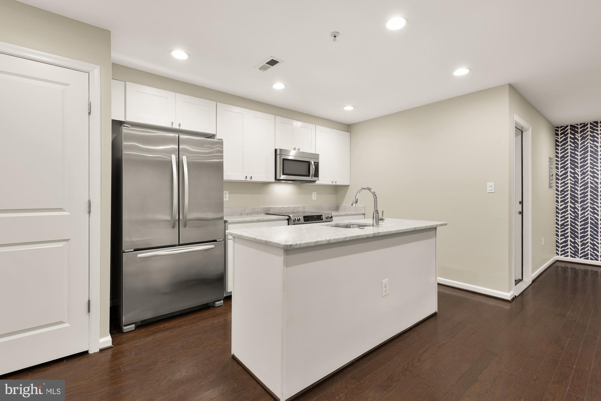 1845 Kalorama Road Northwest, Unit 1 Washington, DC 20009 - Photo 6 of 39 a kitchen with stainless steel appliances granite countertop a refrigerator stove and sink
