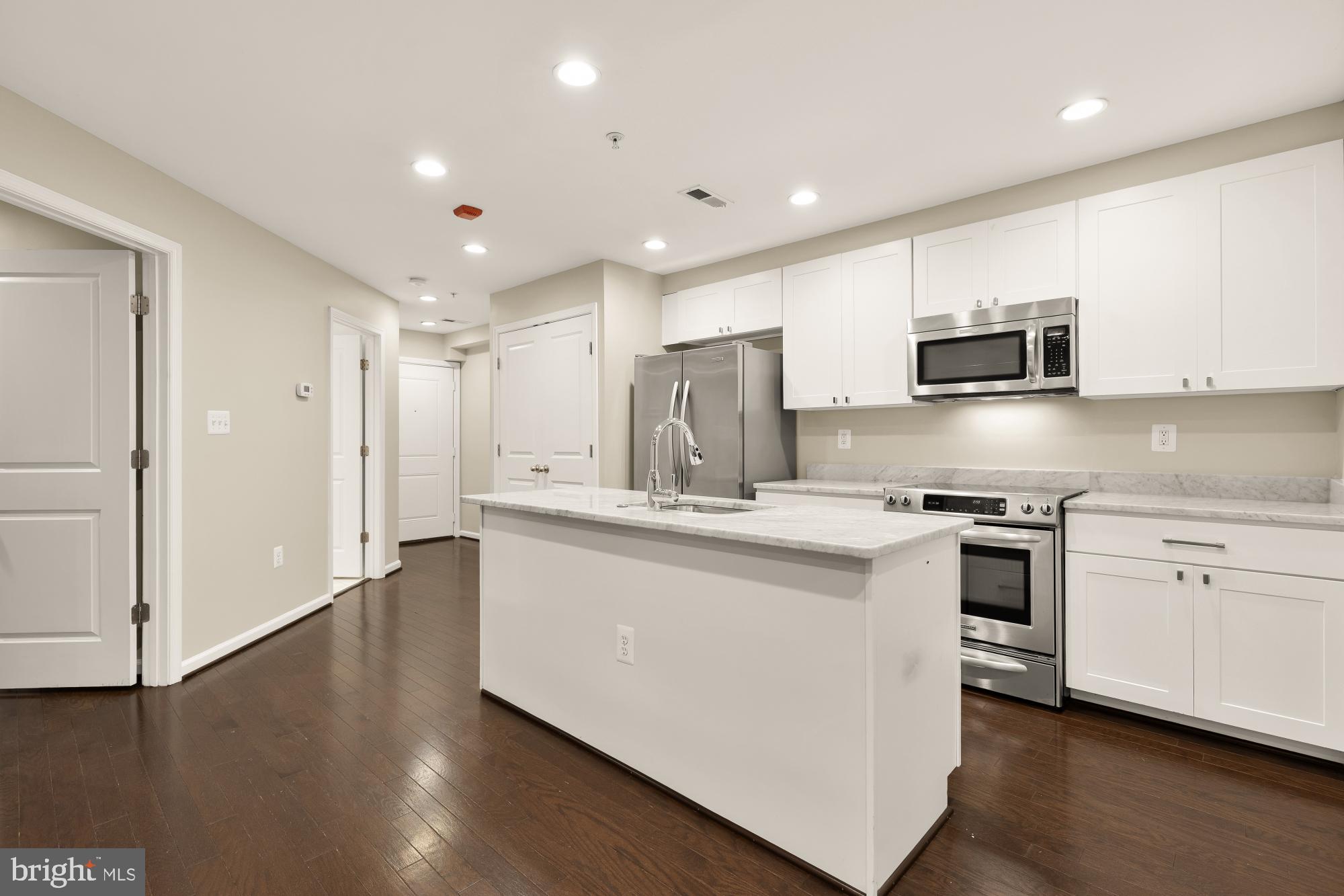 1845 Kalorama Road Northwest, Unit 1 Washington, DC 20009 - Photo 8 of 39 a kitchen with stainless steel appliances granite countertop a stove a sink and a refrigerator
