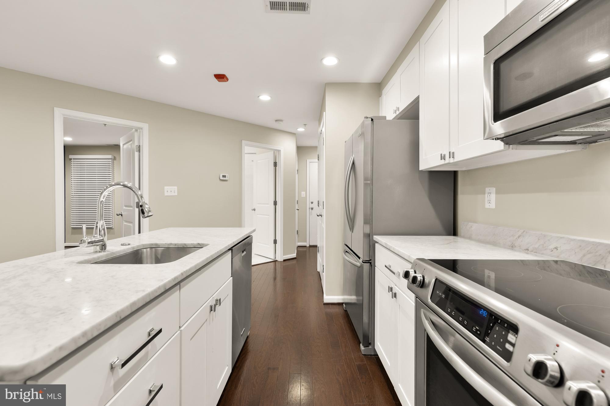 1845 Kalorama Road Northwest, Unit 1 Washington, DC 20009 - Photo 10 of 39 a kitchen with a sink stove and cabinets