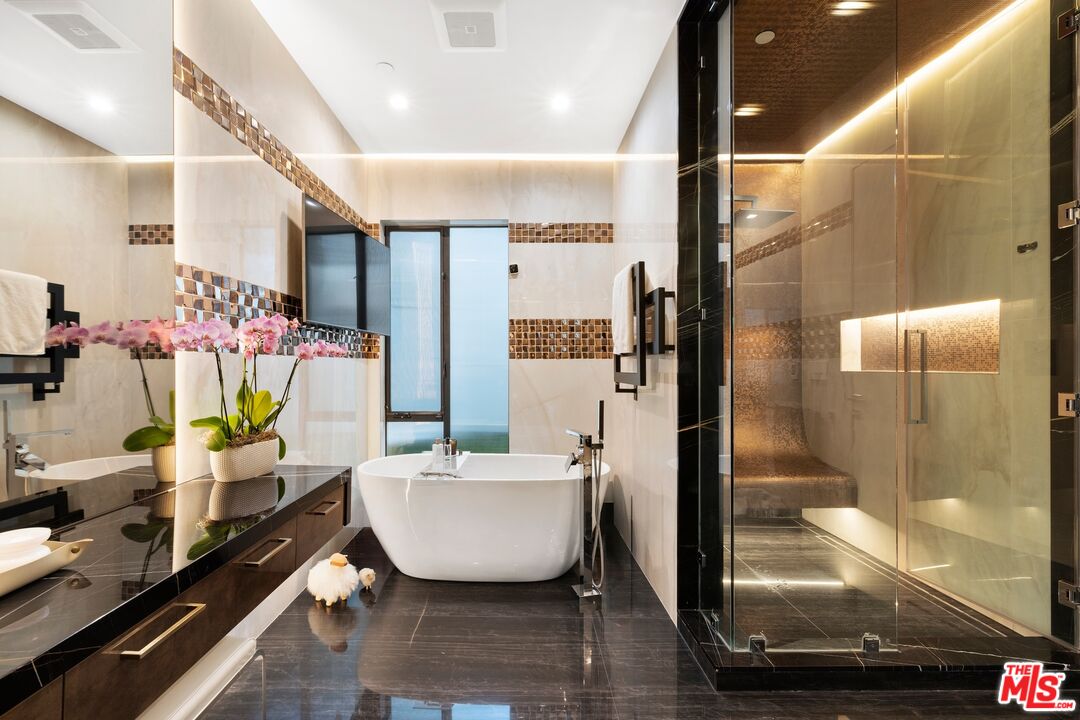 976 Bel Air Road Los Angeles, CA 90077 - Photo 11 of 23 a bathroom with a bathtub and shower