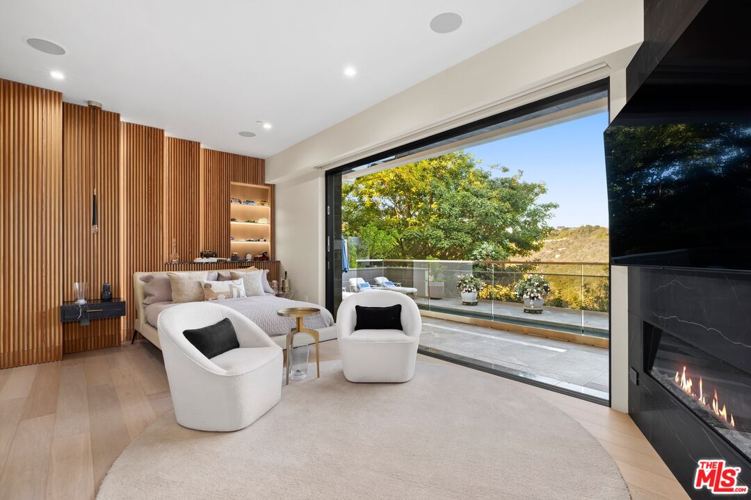976 Bel Air Road Los Angeles, CA 90077 - Photo 13 of 23 a living room with furniture and a flat screen tv