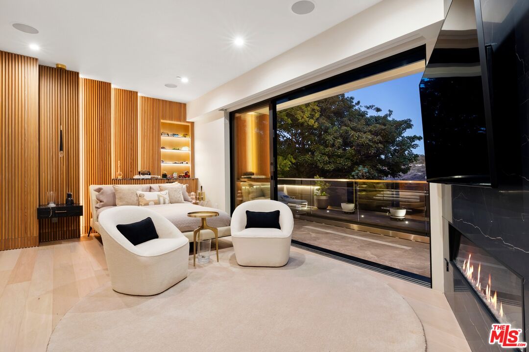 976 Bel Air Road Los Angeles, CA 90077 - Photo 14 of 23 a living room with furniture and a flat screen tv