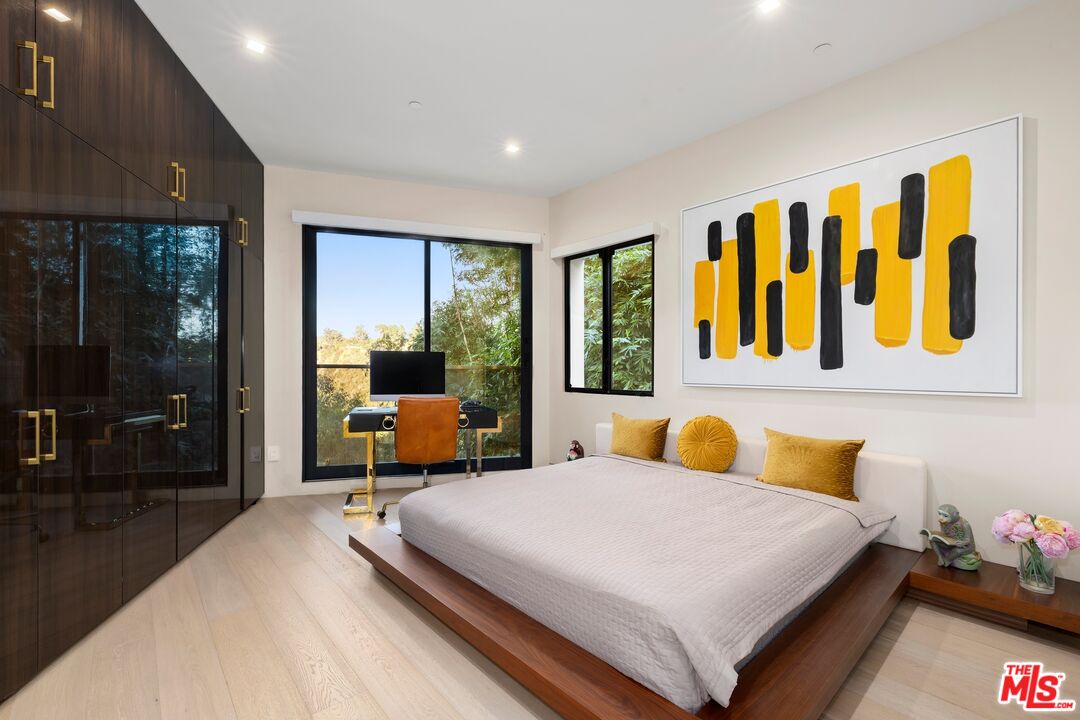 976 Bel Air Road Los Angeles, CA 90077 - Photo 16 of 23 a bedroom with a bed and wooden floor