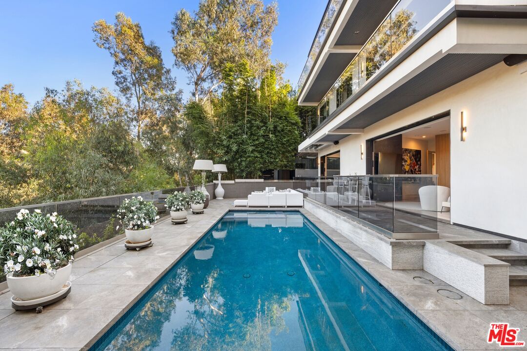 976 Bel Air Road Los Angeles, CA 90077 - Photo 18 of 23 a view of a swimming pool with a patio