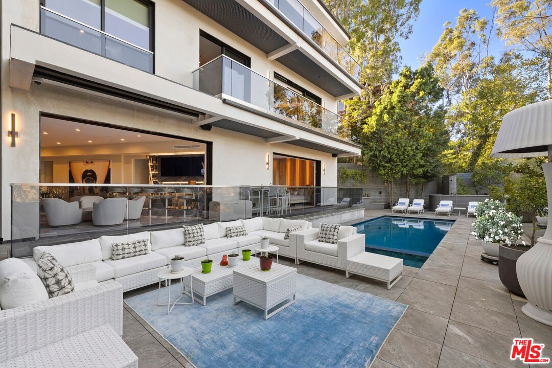 976 Bel Air Road Los Angeles, CA 90077 - Photo 19 of 23 a view of a patio with couches table and chairs and potted plants