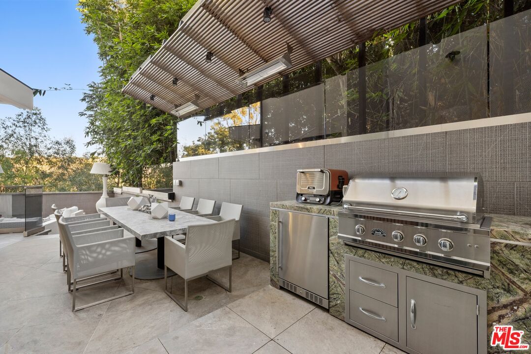 976 Bel Air Road Los Angeles, CA 90077 - Photo 20 of 23 a roof deck with table and chairs