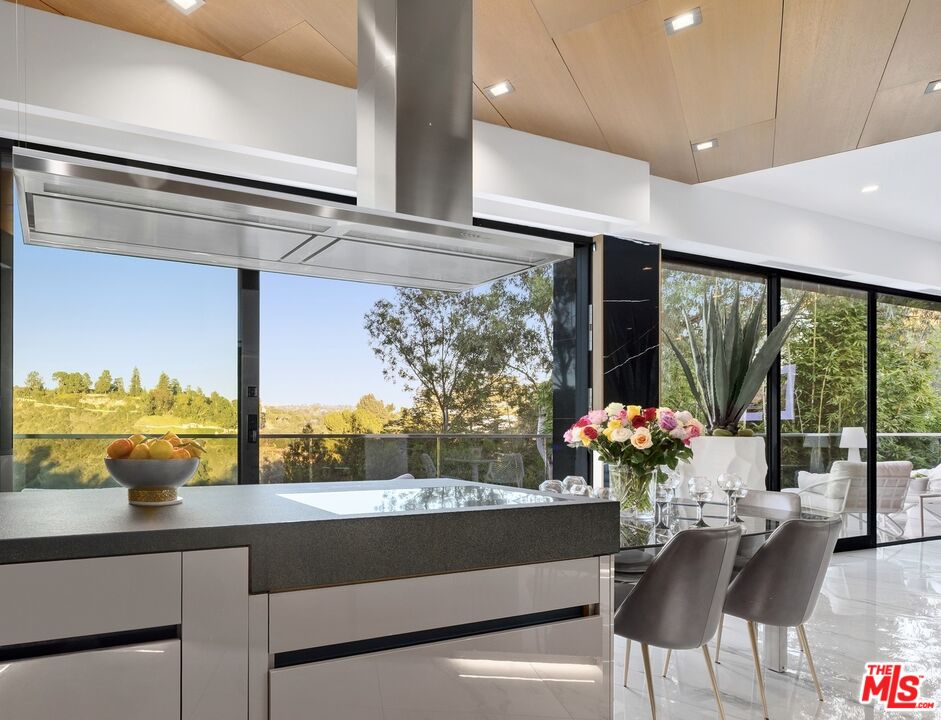 976 Bel Air Road Los Angeles, CA 90077 - Photo 6 of 23 a view of a dining room with furniture window and outside view