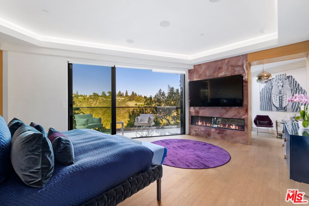 976 Bel Air Road Los Angeles, CA 90077 - Photo 8 of 23 a living room with furniture and a flat screen tv