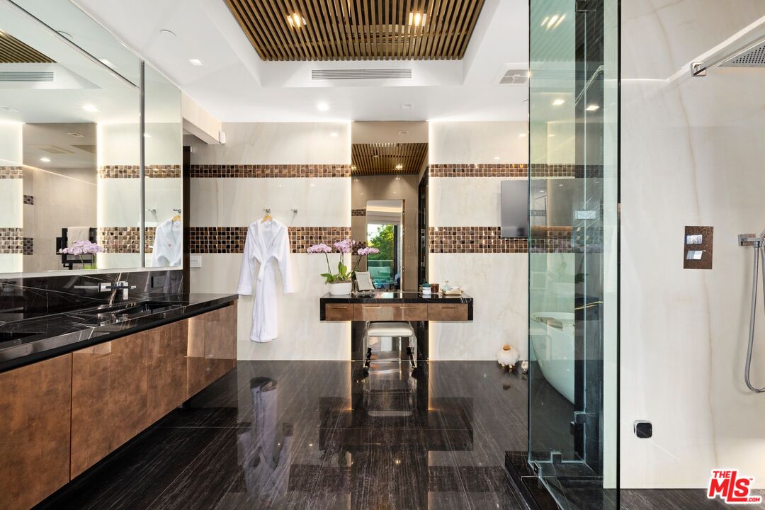 976 Bel Air Road Los Angeles, CA 90077 - Photo 10 of 23 a kitchen with stainless steel appliances granite countertop a stove and refrigerator