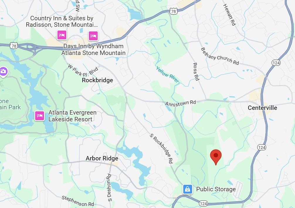 3840 Mountain Cove Road Snellville, GA 30039 - Photo 4 of 4 a picture of a book in a lot of next to a yard