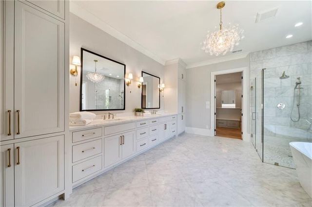 a spacious bathroom with a double vanity sink and a mirror