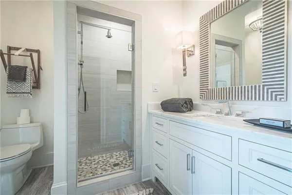 a bathroom with a sink a toilet and shower