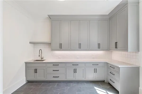 a kitchen with cabinets appliances and a sink