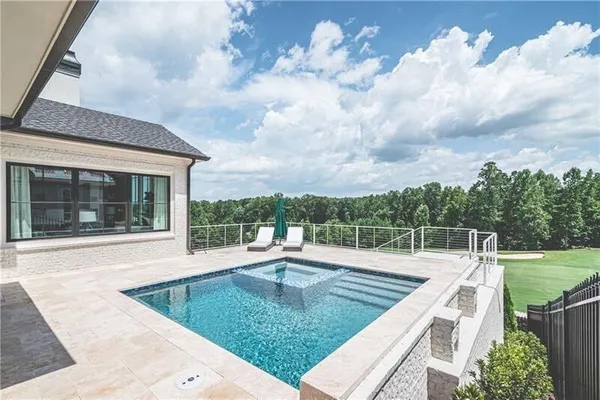 a view of a backyard with sitting area