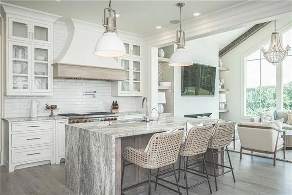 a kitchen with a stove a sink a dining table and chairs