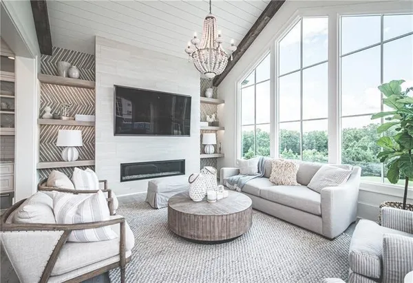 a living room with furniture a fireplace and a flat screen tv
