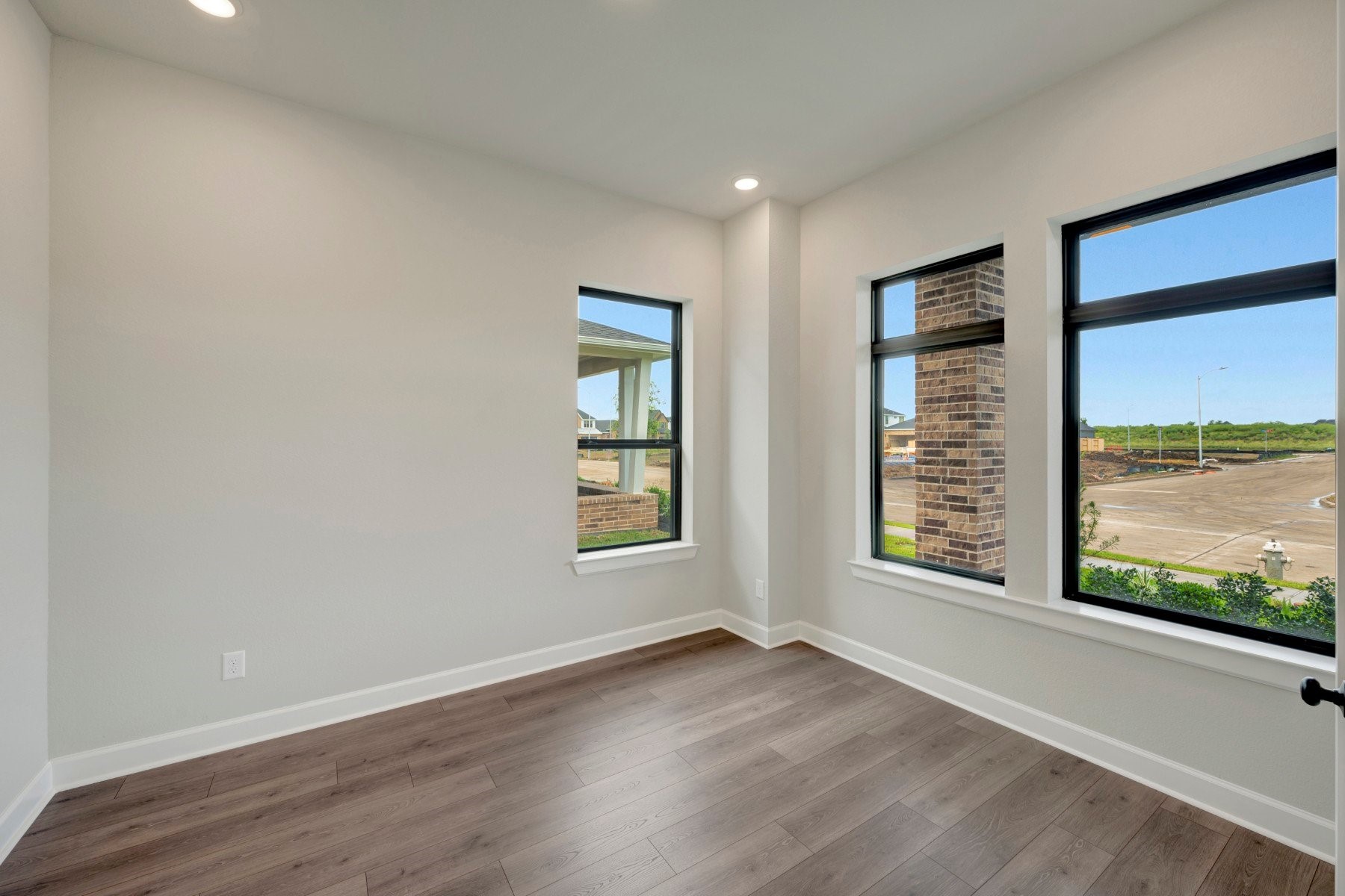 2722 Cottage Place Rosharon, TX 77583 - Photo 16 of 50 an empty room with wooden floor and windows