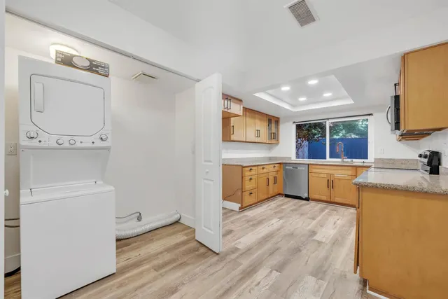 a kitchen with a refrigerator sink and white cabinets