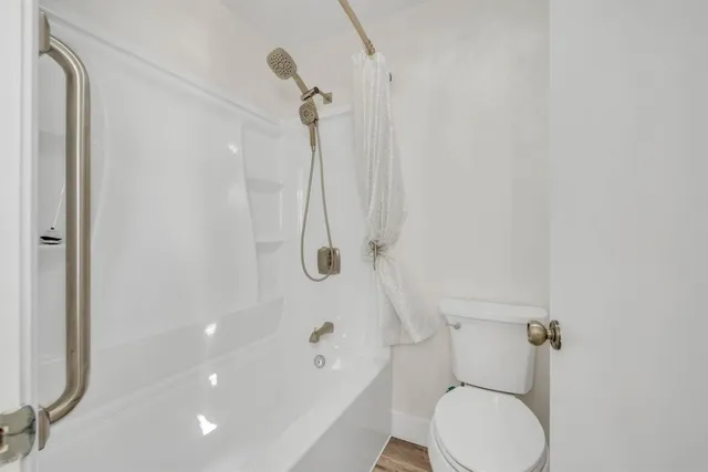 a bathroom with a toilet and a shower