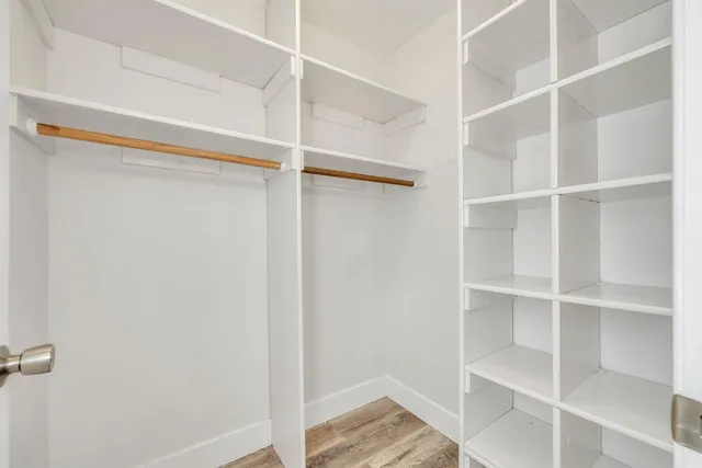 a view of walk in closet with empty racks