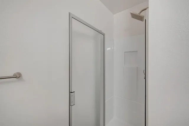 a bathroom with a glass shower door