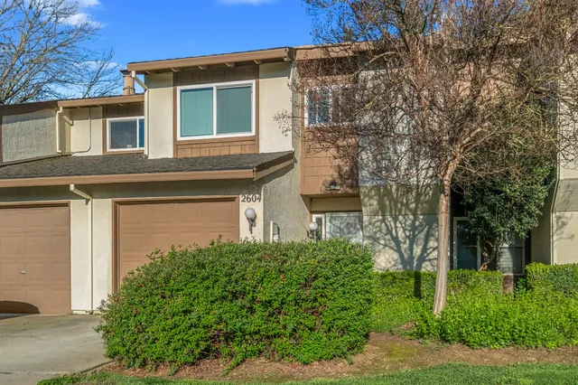 front view of a house with a tree