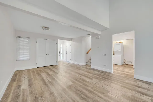 a view of an empty room and wooden floor