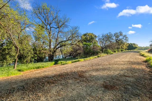 a view of a road with a house in the background