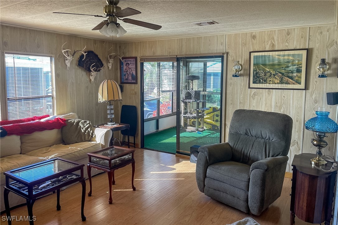 22 Ashe Alva, FL 33920 - Photo 12 of 42 a living room with furniture and a floor to ceiling window
