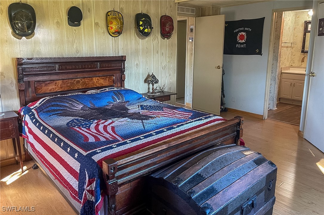 22 Ashe Alva, FL 33920 - Photo 15 of 42 a bedroom with a bed and painting on the wall