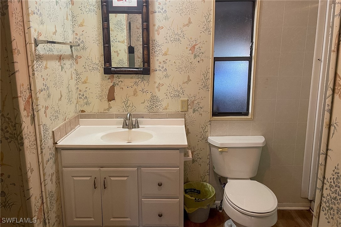 22 Ashe Alva, FL 33920 - Photo 20 of 42 a bathroom with a toilet sink and mirror