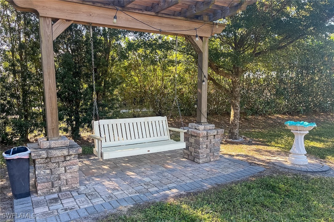 22 Ashe Alva, FL 33920 - Photo 32 of 42 a view of a patio with a table and chairs