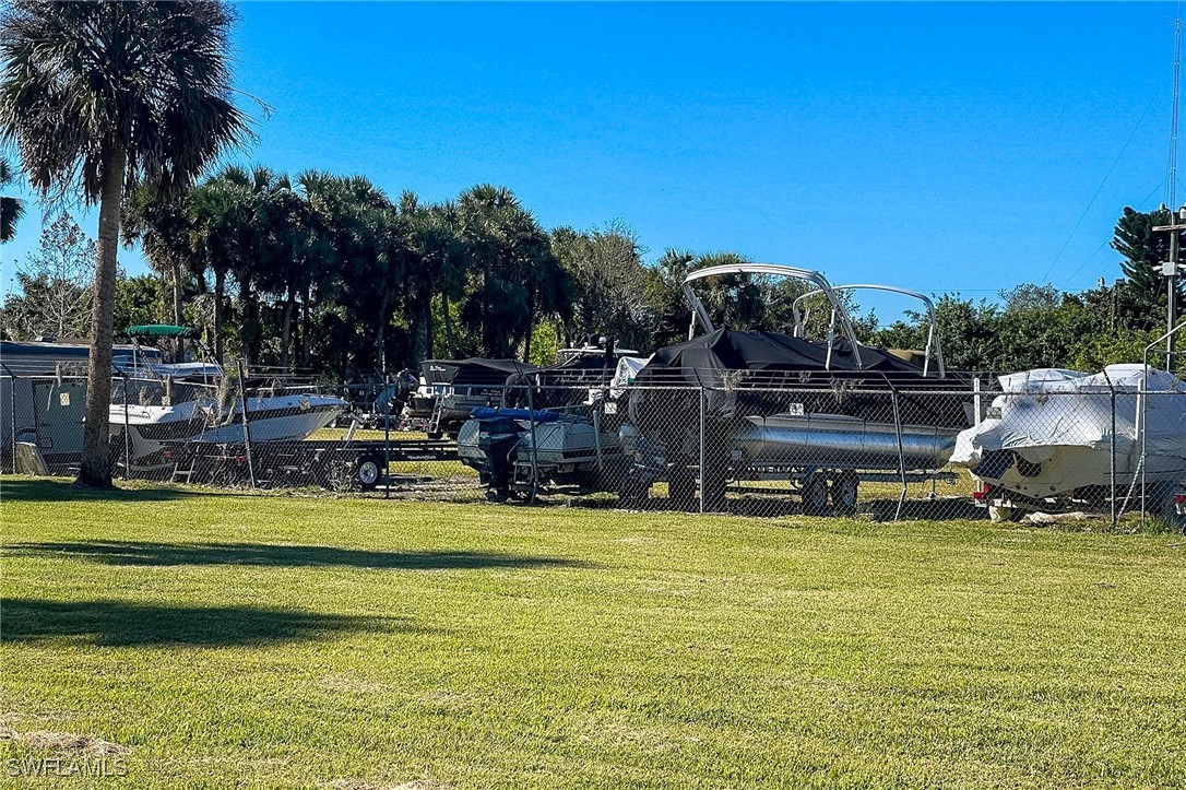 22 Ashe Alva, FL 33920 - Photo 39 of 42 a view of a swimming pool with lawn chairs and a fire pit