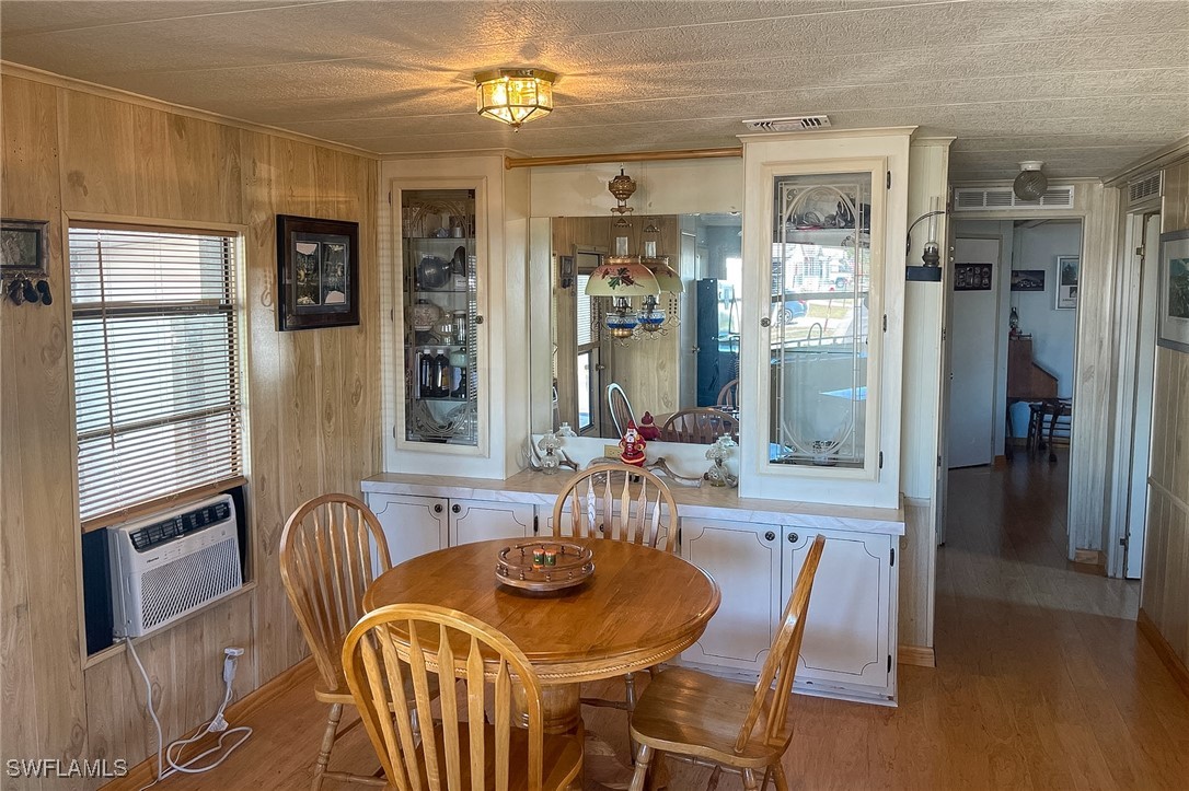 22 Ashe Alva, FL 33920 - Photo 5 of 42 a dining room with furniture a flat screen tv and kitchen view