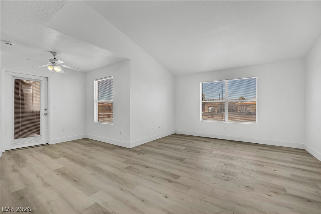 8101 West Flamingo Road, Unit 2030 Las Vegas, NV 89147 - Photo 16 of 27 Bright, open-concept living space boasts sleek wood flooring and ample natural light.