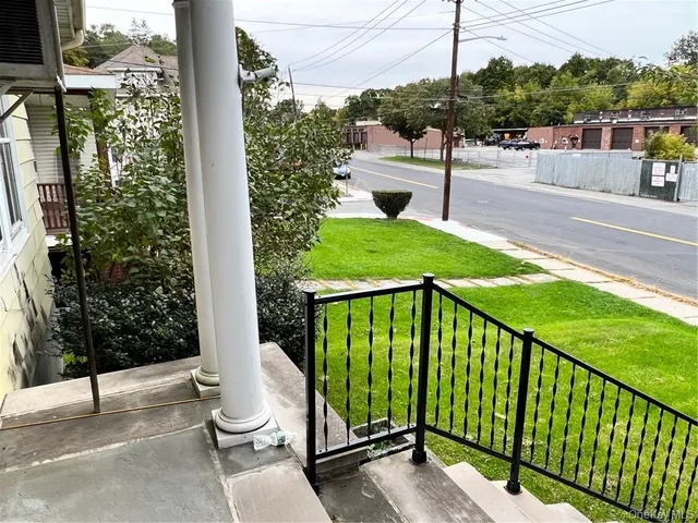 a view of empty room with wooden floor and cabinet
