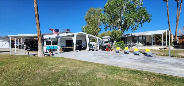 a view of a house with swimming pool and sitting area