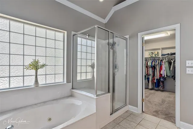 a view of a bathroom with a tub and shower