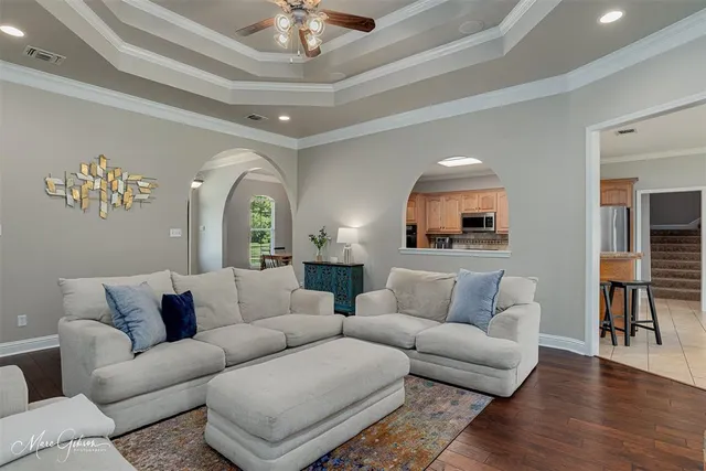 a living room with furniture and a chandelier