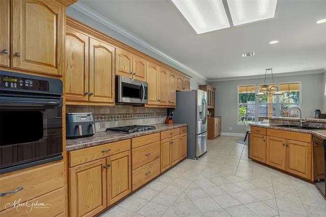 a kitchen with granite countertop cabinets stainless steel appliances and a sink