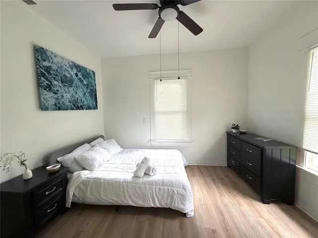 a bedroom with a bed and wooden floor