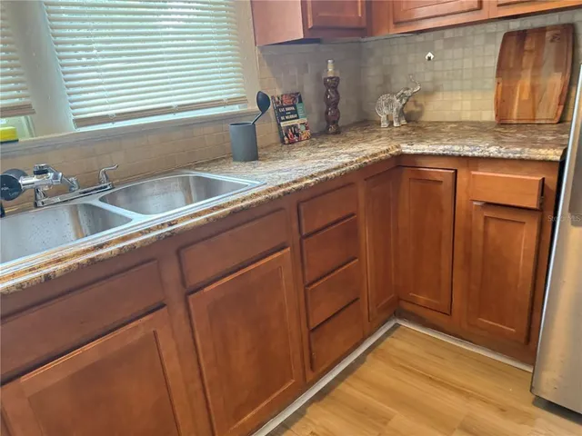 a kitchen with granite countertop a sink and a window